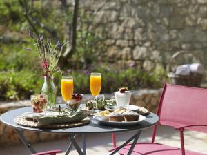a table with food and two glasses of orange juice at Leivatho Hotel in Svoronata