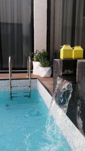 a swimming pool with a water fountain in a building at STAY Villa in Riyadh