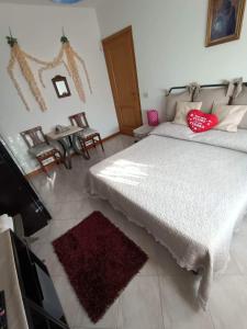 a bedroom with a large white bed with red pillows at Wanderful room in Cinquale