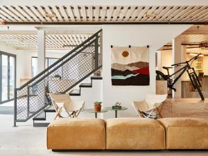 a living room with a couch and a staircase at Field Station Joshua Tree in Yucca Valley