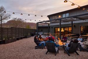 a group of people sitting around a fire pit at Field Station Joshua Tree in Yucca Valley