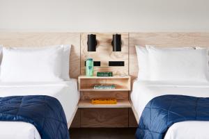 two beds sitting next to each other in a room at Field Station Joshua Tree in Yucca Valley