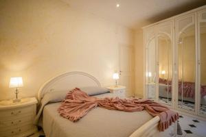 a bedroom with a bed and a dresser and a mirror at Mare In Vista in Capoliveri
