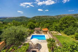 an aerial view of a villa with a swimming pool at Villa Cocoon - Vacation Home with Heated Pool & Garden in Bribir