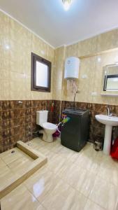 a bathroom with a toilet and a sink at جراند هيلز الساحل الشمالي Grand Hills North Coast شالية فندقي كود H047 in Dawwār ‘Abd Allāh