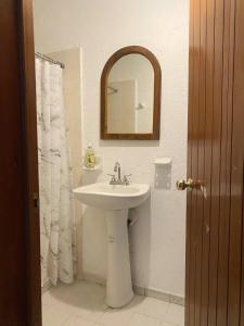 a bathroom with a sink and a mirror at Hotel del Callejón in Zihuatanejo +13 photos