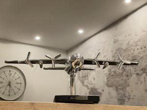 a plane on a shelf with a clock on a wall at Ferienhaus Hallix in Sande