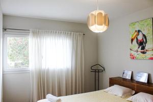 a bedroom with a bed and a window at Okira beach house in Aguda +39 photos