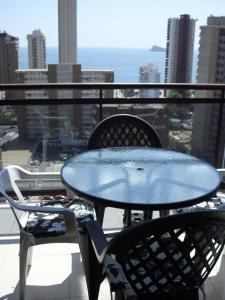 a blue table and two chairs on a balcony at Torremar 17 vistas al mar Benidorm in Benidorm