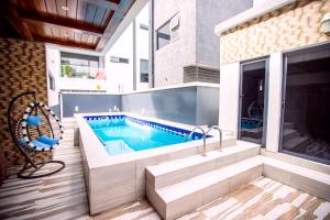a swimming pool in the middle of a house at Rushmore - Premier 1 Room in Lagos