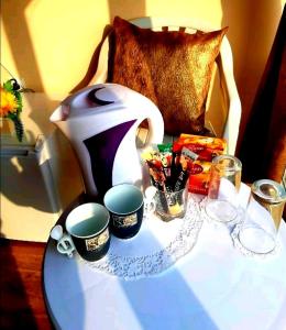 a table with a tea pot and cups on it at Къща за гости Вълчеви Несебър in Nesebar