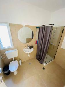 a bathroom with a toilet sink and a mirror at Incredible roof in Florentin in Tel Aviv