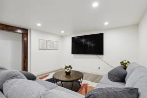 a living room with a couch and a tv at Family-Friendly Provo Vacation Rental Near BYU! in Provo