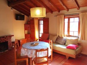 a living room with a couch and a table at Casas do Cruzeiro in Sabugueiro