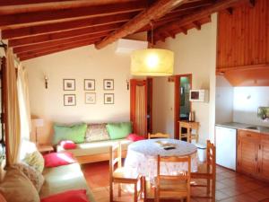 a living room with a couch and a table at Casas do Cruzeiro in Sabugueiro