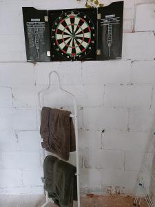 a dart board hanging on a wall with towels at The White Dove Bed and Breakfast and Bell Tents 1 in Newark upon Trent