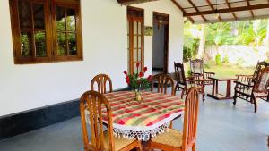 a table and chairs on a porch with a table at Son'S Villa in Ahangama +33 photos