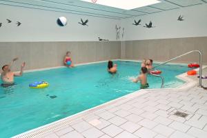 a group of people playing in a swimming pool at Frieda in Zingst