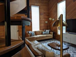 a living room with a couch and a bunk bed at Base Camp in Cortland