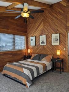 a bedroom with a bed and a ceiling fan at Base Camp in Cortland