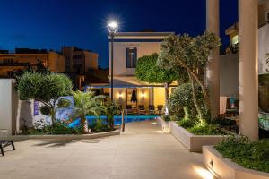 a villa with a swimming pool at night at Creta Elena in Chania