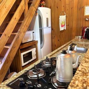 a kitchen with a stove with a tea kettle on it at Recanto Paraíso da Colina in Santo Amaro da Imperatriz