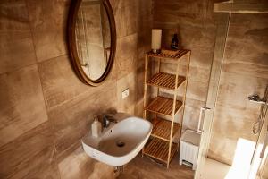 a bathroom with a sink and a mirror at Il Torrione del Trebbia in Bobbio +49 photos