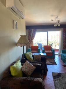 a living room with a couch and a table at Gulf Porto Marina Call First in El Alamein