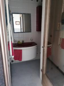 a bathroom with a tub and a sink and a mirror at Otranto Mon Amour in Otranto