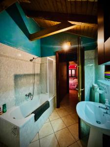 a bathroom with a tub and a sink at Nel cuore di Saint Vincent in Saint Vincent