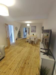 a living room with a table and a dining room at Cosy 3-Bed house in Clydach - TV in every bedroom! in Clydach