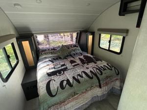 a bedroom in a camper with a bed in it at Dominion Hill Country Inn in Bocabec