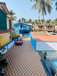 a car parked in front of a blue house at Blue rays in Calangute