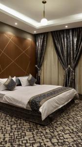 a large bedroom with a large bed with curtains at شقق فاتوران الفاخره in Medina