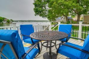 a table and chairs on a deck with a view of the water at Sun-Soaked Wareham Cottage with River Access! in Wareham