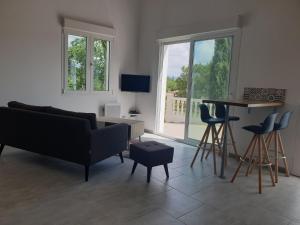 a living room with a couch and a table at Gîtes L'HERMITAGE in La Tour-dʼAigues