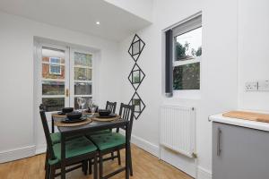 a kitchen and dining room with a table and chairs at Timeless Elegance 4-Bed Victorian Charm in Leicester