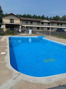 a large blue swimming pool in front of a building at Malibu Inn in Wisconsin Dells