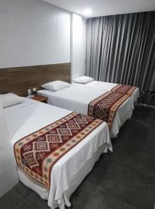 Łóżko lub łóżka w pokoju w obiekcie EMA HOTEL