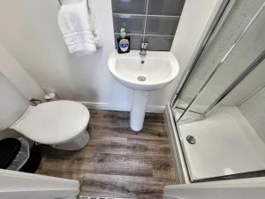 a bathroom with a toilet and a sink and a shower at Stay Sleep Rest - NG2 in Nottingham