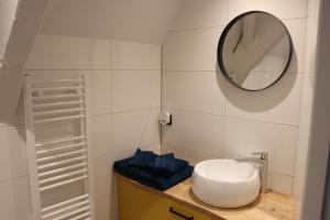 a bathroom with a sink and a mirror on a counter at Elysian Yellow Suite in Middelburg