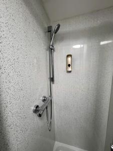 a shower in the corner of a bathroom at Stay Sleep Rest - NG2 in Nottingham