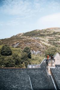 una casa con una montaña en el fondo en Menstrie Castle Stay en Stirling