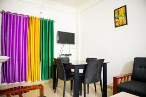 TV at/o entertainment center sa Green Apartments - AC 1 BHK Apartments in Cheruthuruthi, Thrissur