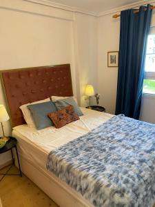 a bedroom with a large bed with blue curtains at Sunylife in Albir +22 photos