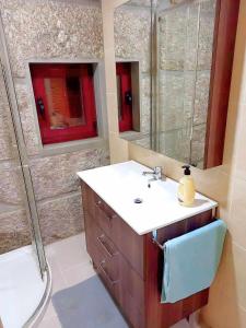 a bathroom with a sink and a shower and a toilet at Stone House Entre os Rios in Entre -os- Rios