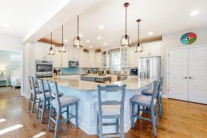 a kitchen with a large island with blue bar stools at Town of Rehoboth Beach 302 Laurel St in Rehoboth Beach