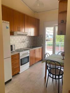 a kitchen with a table and a white stove top oven at Dolphin in Kavala