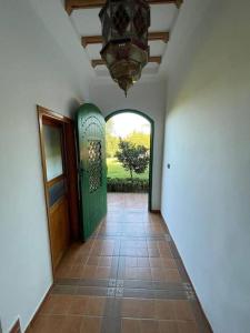 a hallway with a door and a tiled floor at Lovely holiday Private villa with nature view +pool in Larache