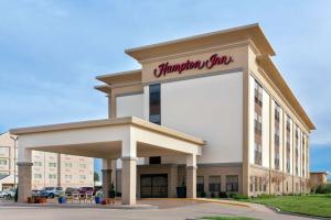a building with a sign for a shopping center at Hampton Inn Abilene in Abilene